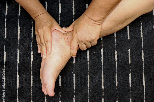 Treating injuries to the feet and leg with the push of a finger according to tricks of  traditional Thai massage .