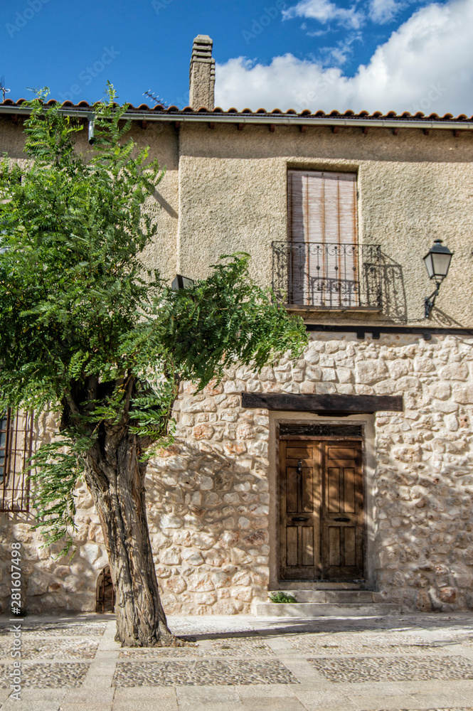 a rural house facade with a tree in Spain