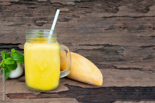 Mango smoothies juice orange fruit juice milkshake blend beverage healthy high protein the taste yummy in glass episode drink morning on wood background.