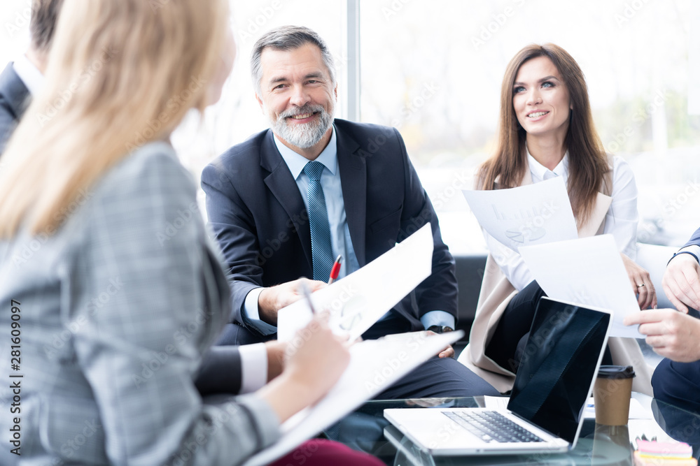 Businesspeople discussing together in conference room during meeting at office. Businesspeople discussing together in conference room during meeting at office.