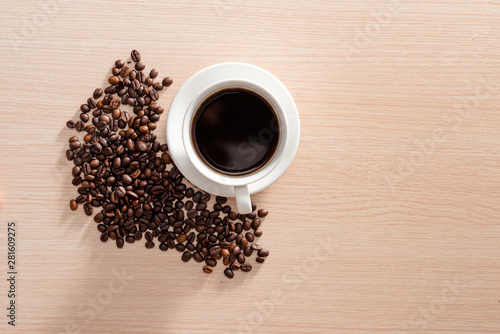 Fototapeta Naklejka Na Ścianę i Meble -  Coffee cup with coffee beans on wooden background