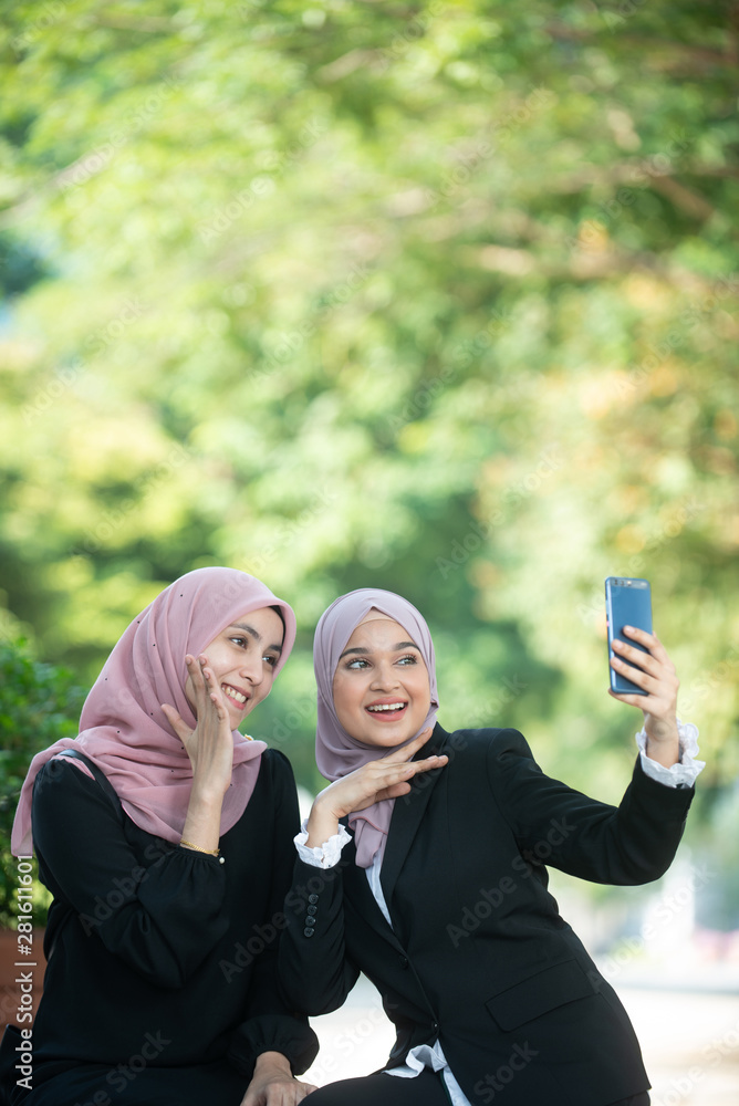 Muslim Business Women taking a Selfie. Outdoor Setting. Muslim Business Women taking a Selfie. Outdoor Setting.