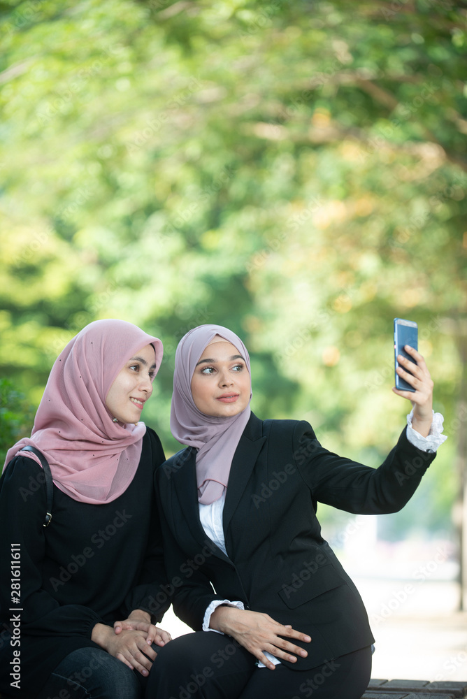Muslim Business Women taking a Selfie. Outdoor Setting. Muslim Business Women taking a Selfie. Outdoor Setting.