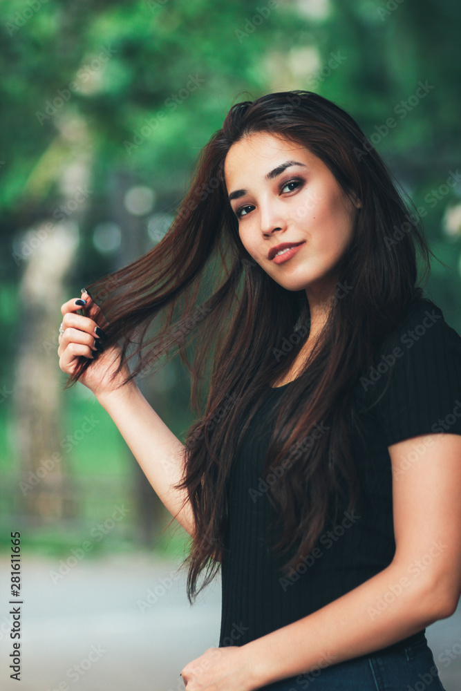 Portrait of beautiful happy long hair asian girl in black t-shirt on street Portrait of beautiful happy long hair asian girl in black t-shirt on street