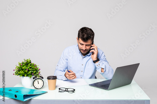 Business, people, communication and technology concept. Businessman calling on smartphone and writing to notebook at office