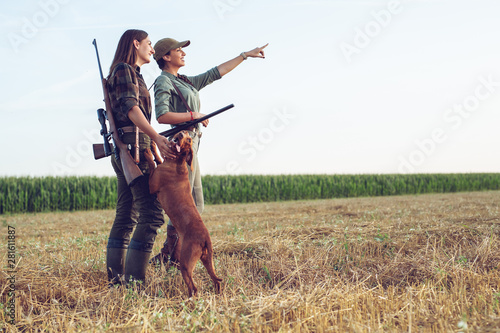 Fototapeta Women hunters with hunting dog
