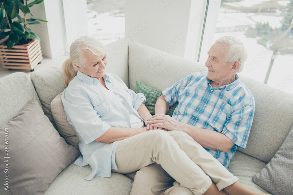 Obraz premium Above high angle view of her she his he two nice attractive lovely cheerful cheery people soulmates sitting on cosy divan spending time in light white interior living-room house
