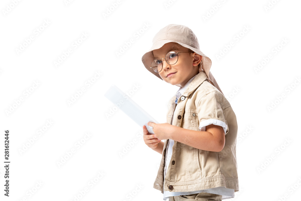 pensive explorer child in glasses and hat holding digital tablet and looking away isolated on white pensive explorer child in glasses and hat holding digital tablet and looking away isolated on white