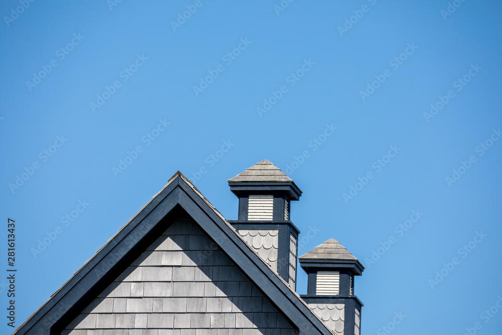 Blue and grey rooftop with two chimneys