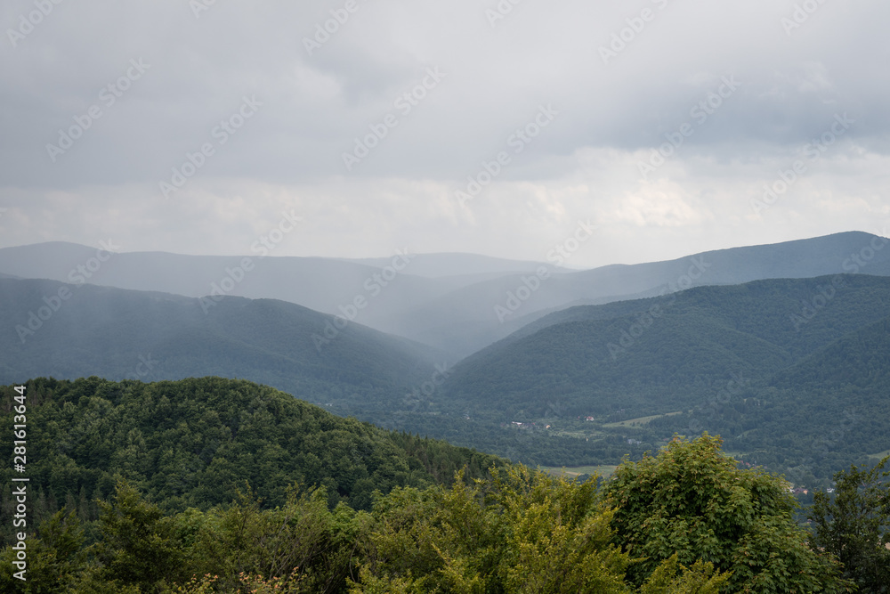 Fototapeta premium A storm is brewing over Wetlina village, seen from Połonina Wetlińska, from the approach to Smerek peak.