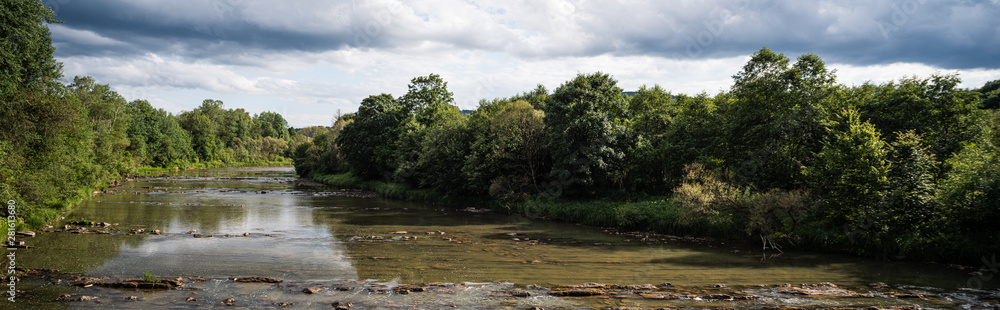 San river flows over parallel rock formations in the Bieszczady Mountains. San river flows over parallel rock formations in the Bieszczady Mountains.