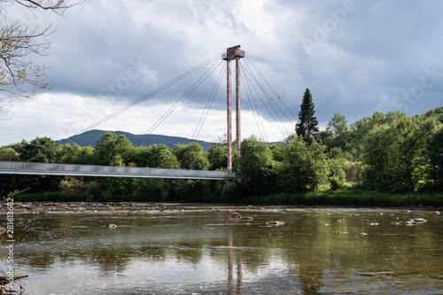 Fototapeta Naklejka Na Ścianę i Meble -  A suspension footbridge with an observation tower stands over the river San at the historic border between Poland and the USSR.