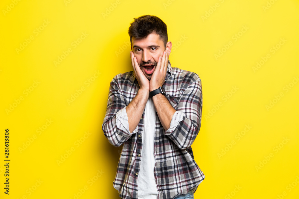 Portrait of scared man in panic nervous excited keeps palm on face, feals fear, isolated on yellow background. Guy shocked by scene in front of him Portrait of scared man in panic nervous excited keeps palm on face, feals fear, isolated on yellow background. Guy shocked by scene in front of him