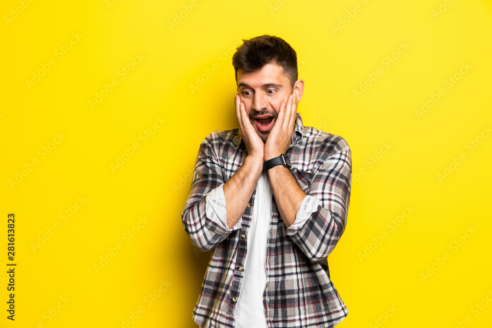 Portrait of scared man in panic nervous excited keeps palm on face, feals fear, isolated on yellow background. Guy shocked by scene in front of him Portrait of scared man in panic nervous excited keeps palm on face, feals fear, isolated on yellow background. Guy shocked by scene in front of him