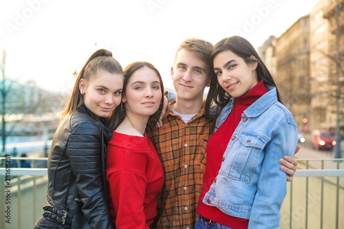 Group of friends hugging and smiling