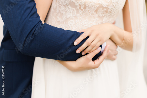  bride and groom hold each other's hand