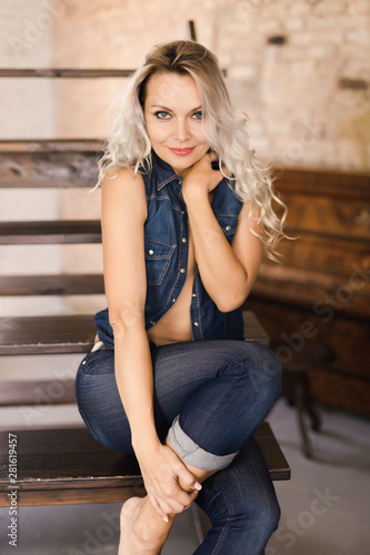  Beautiful sexy blonde in jeans and a denim vest