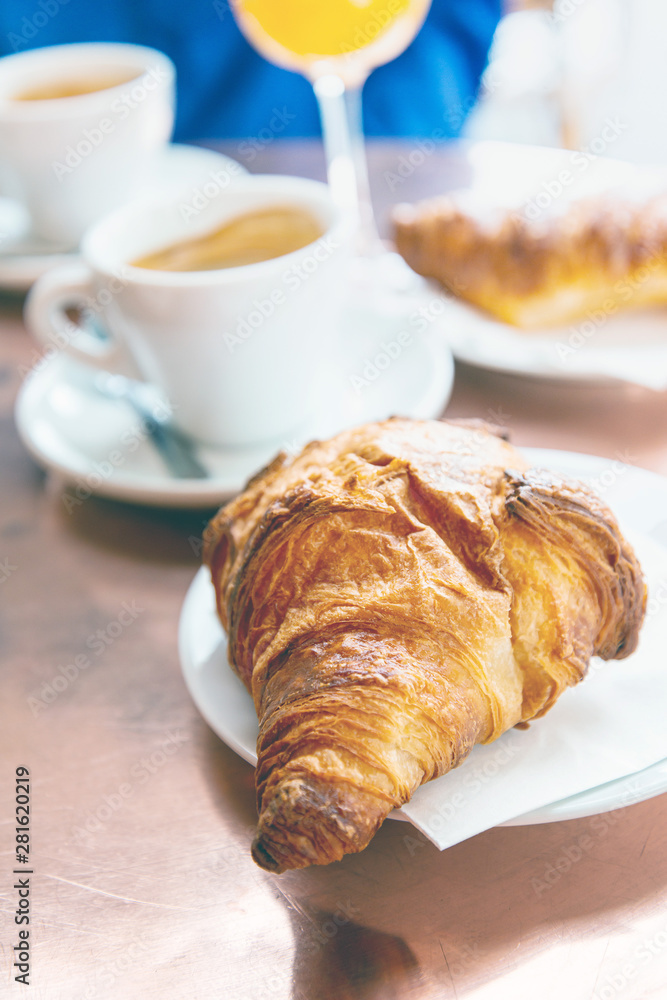 Breakfast with coffee and croissants on table Breakfast with coffee and croissants on table