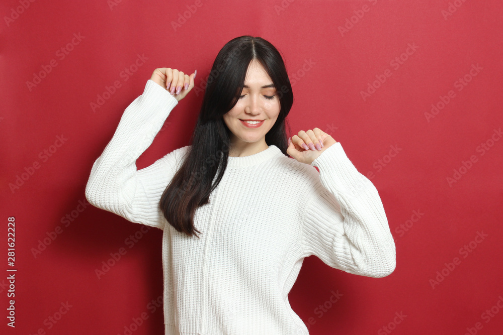 Beautiful girl in a warm cozy sweater on a colored background. Beautiful girl in a warm cozy sweater on a colored background.