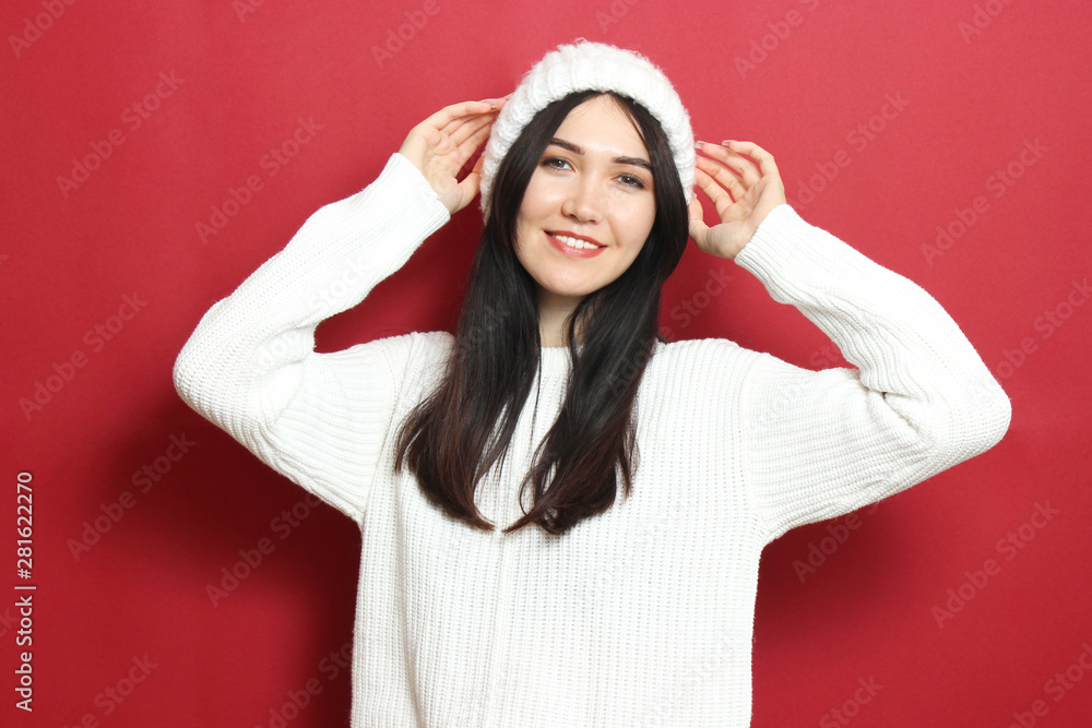 Beautiful girl in a warm cozy sweater on a colored background. Beautiful girl in a warm cozy sweater on a colored background.