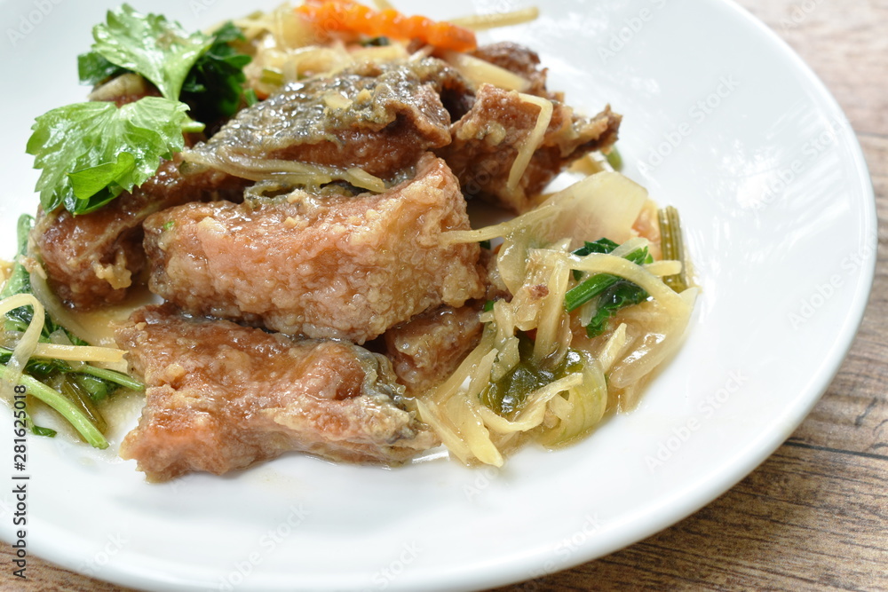 deep fried chop fish with slice ginger and celery on plate deep fried chop fish with slice ginger and celery on plate