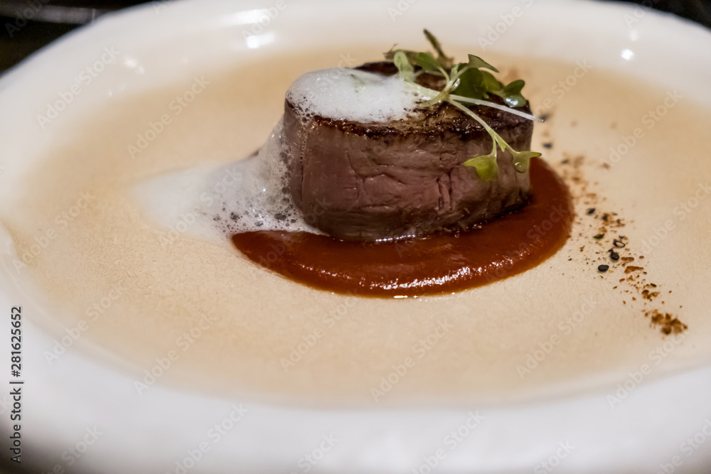 Juicy delicious beef fillet steak mignon served on a plate in a restaurant Juicy delicious beef fillet steak mignon served on a plate in a restaurant