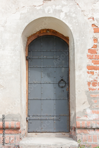 The entrance to the old stone building, metal door