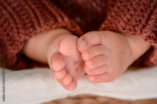 Photo of newborn baby feet, soft focus.