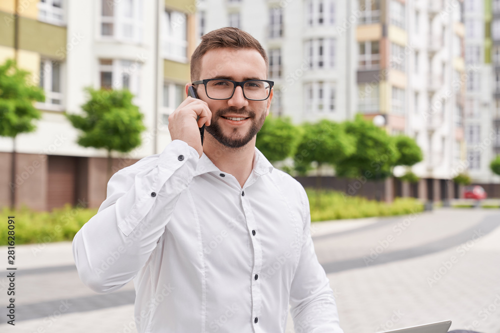 Bearded man with phone posing, looking at camera. Bearded man with phone posing, looking at camera.