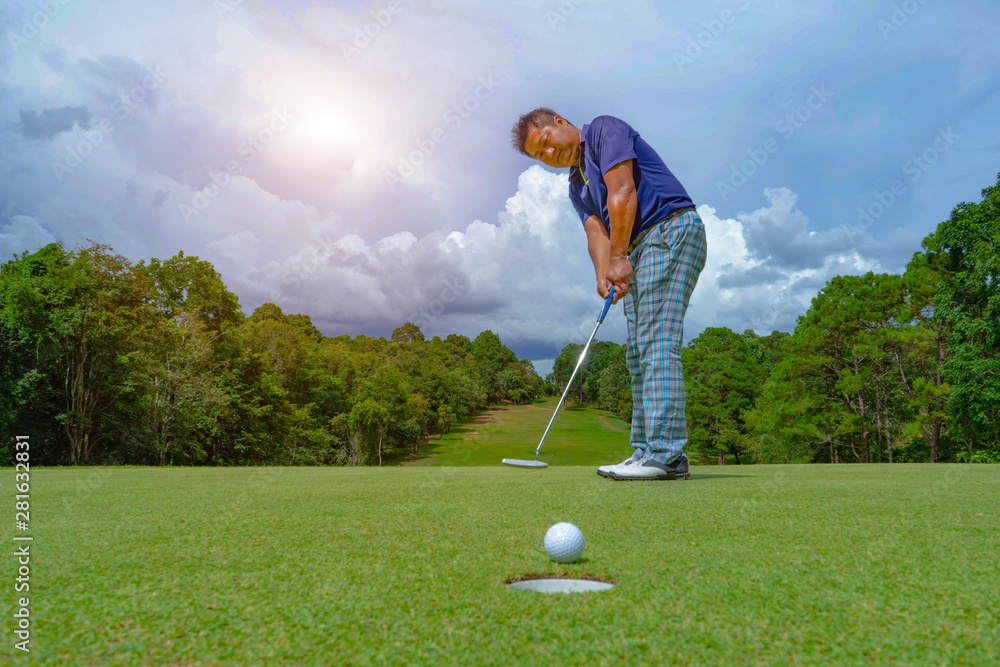Fototapeta premium Golfer playing golf in beautiful golf course in the evening golf course with sunshine in thailand
