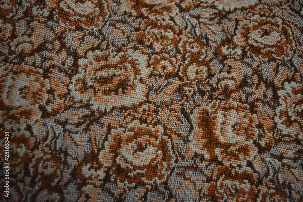Unusual thick fabric of thick, thick threads with brown color patterns and colors. Dense coverlet, canvas of synthetic material, unusual background. Unusual thick fabric of thick, thick threads with brown color patterns and colors. Dense coverlet, canvas of synthetic material, unusual background.