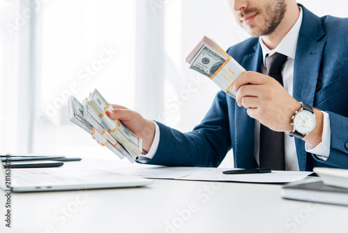 selective focus of businessman gesturing near money and contract on table