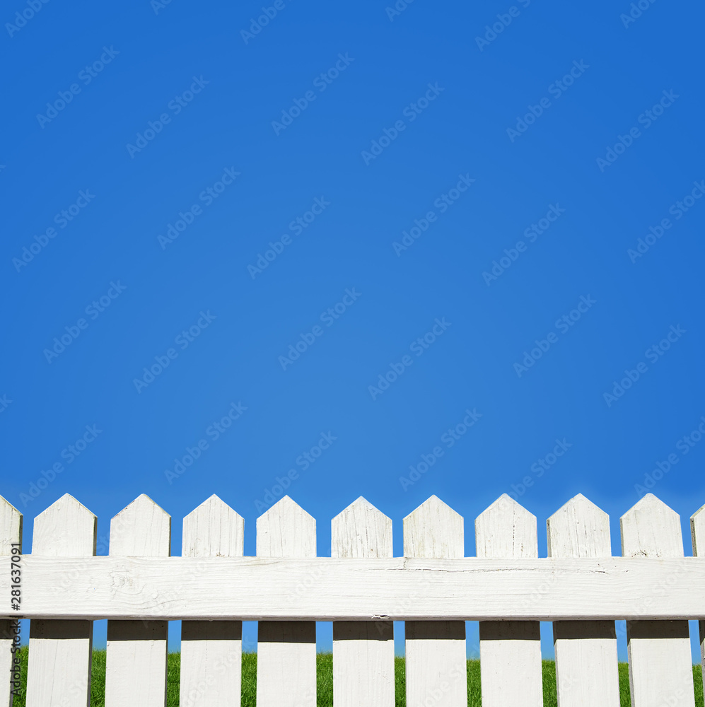 White picket fence and blue sky