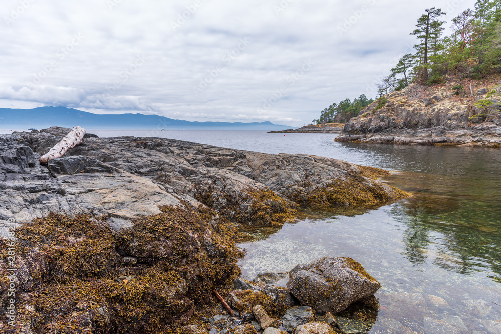 View over Burrard Inlet, ocean and island with boat and mountains in beautiful British Columbia. Canada. View over Burrard Inlet, ocean and island with boat and mountains in beautiful British Columbia. Canada.