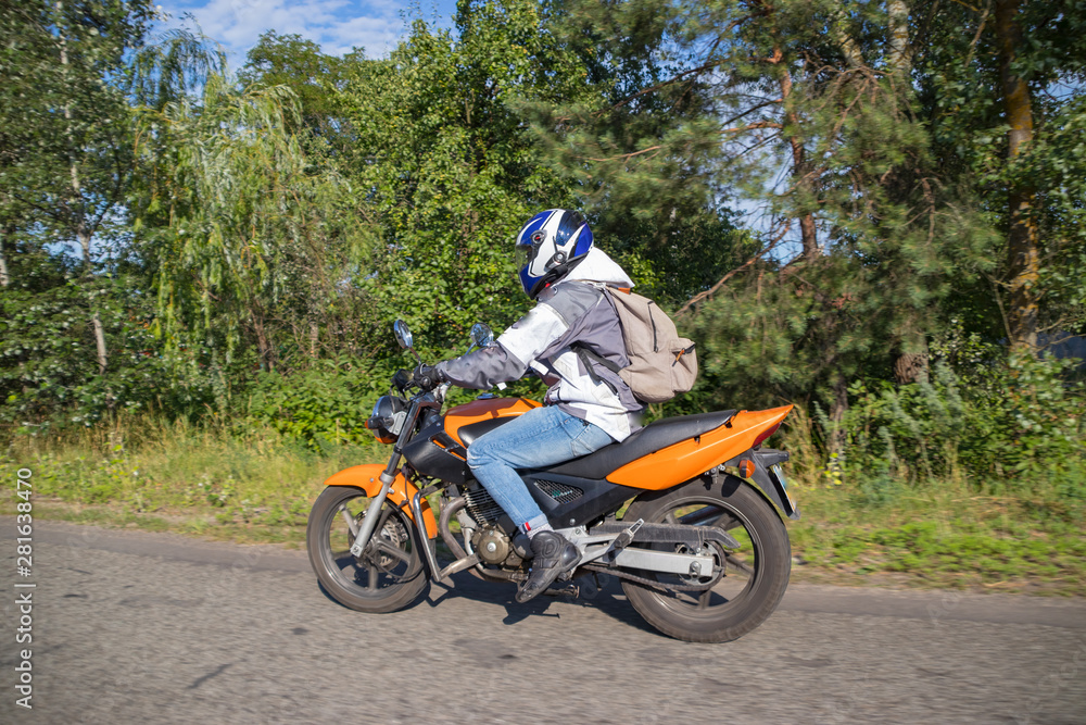 Motorcyclist biker driving on the highway Motorcyclist biker driving on the highway