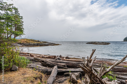 View over Burrard Inlet, ocean and island with boat and mountains in beautiful British Columbia. Canada.