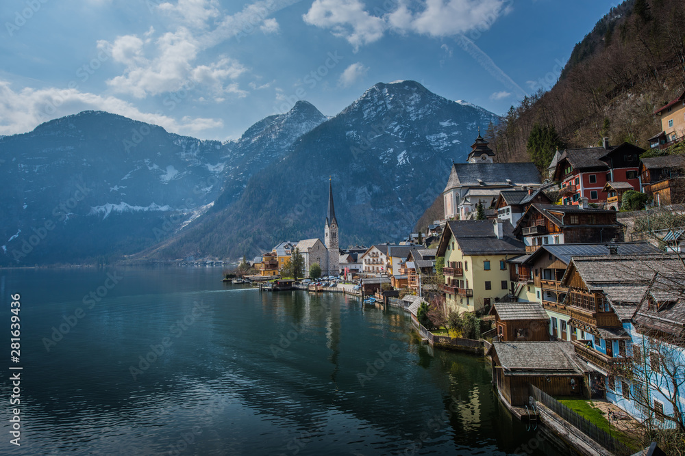 Popular scenic view of Hallstatt town, Austria in summer time with blue sky and clear lake