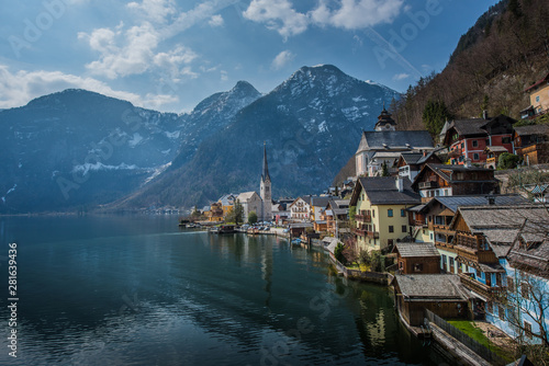 Popular scenic view of Hallstatt town, Austria in summer time with blue sky and clear lake