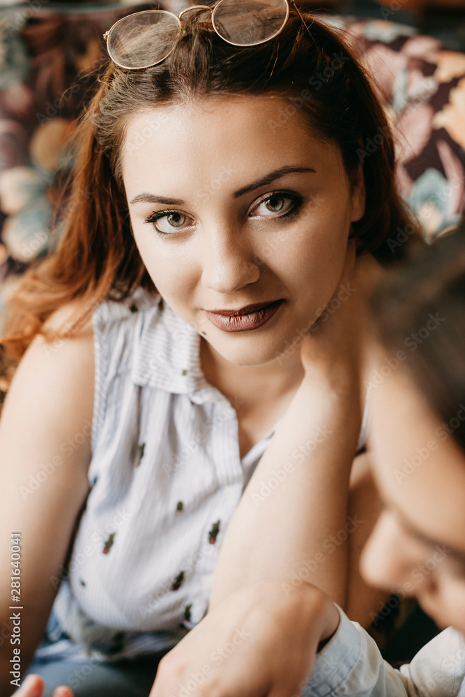Close up portrait of a beautiful plus size woman looking at camera smiling touching her neck. Close up portrait of a beautiful plus size woman looking at camera smiling touching her neck.
