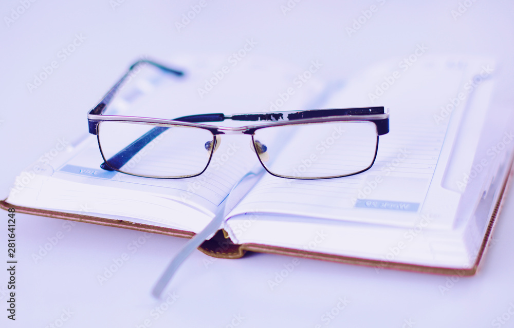 Group of multicolored office folders and glasses Group of multicolored office folders and glasses