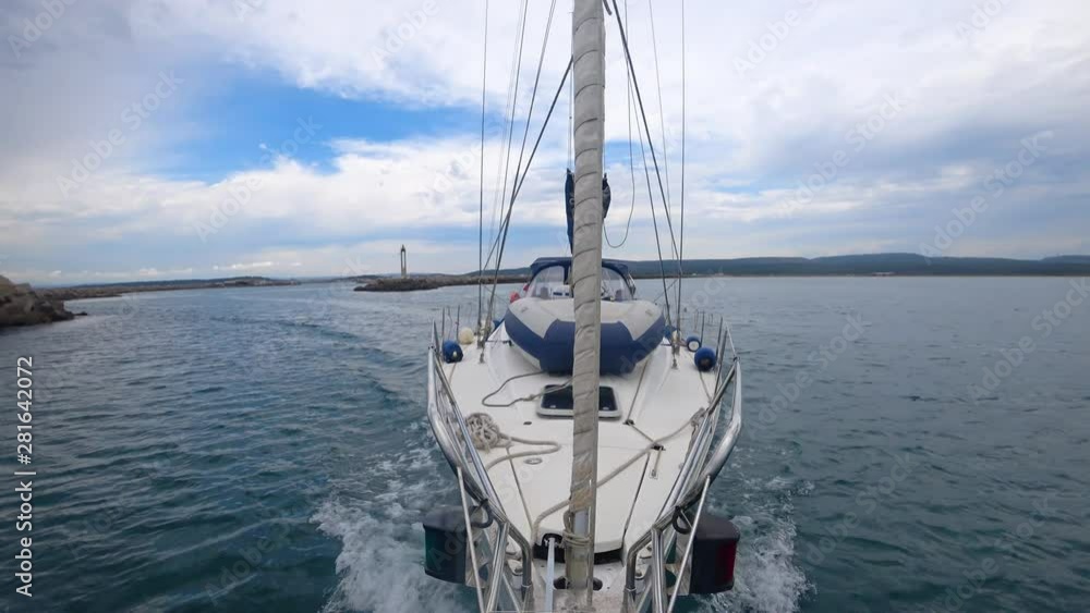 yacht sailing on a motor without sails; view from the bow to the yacht yacht sailing on a motor without sails; view from the bow to the yacht
