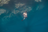 Free diving in a clear and shallow reef.