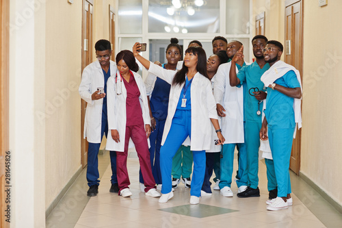 Group of african medical students in college making selfie together on phone.
