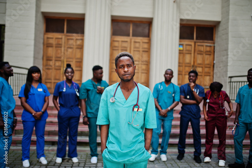 Group of african medical students posed outdoor against university door.