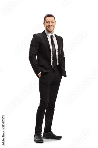 Картината върху платно Young man wearing a modern black suit and smiling