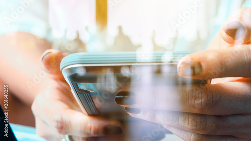 Hands with mobile, double exposure
