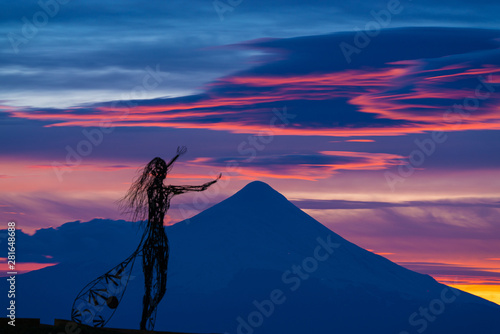 Zoom shot of beautiful sunrise colors on the shore of Lake Llanquihue with the unmistaken Osorno volcano in the background