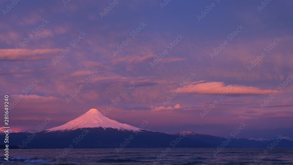 beautiful sunset colors in the sky and over the glacier and snow of the Osorno volcano