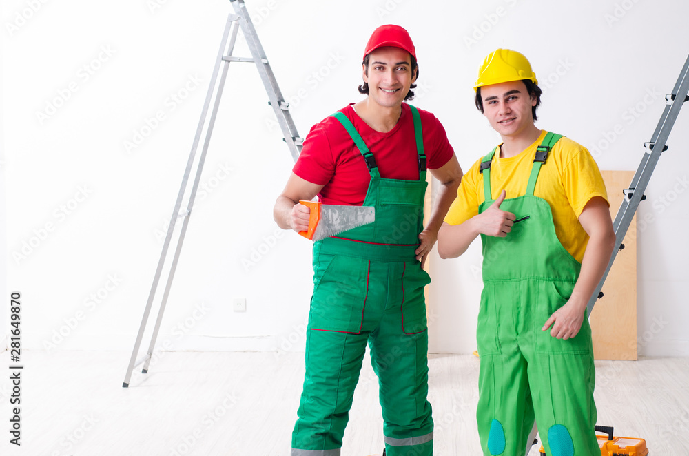 Two workers contractors working indoors Two workers contractors working indoors