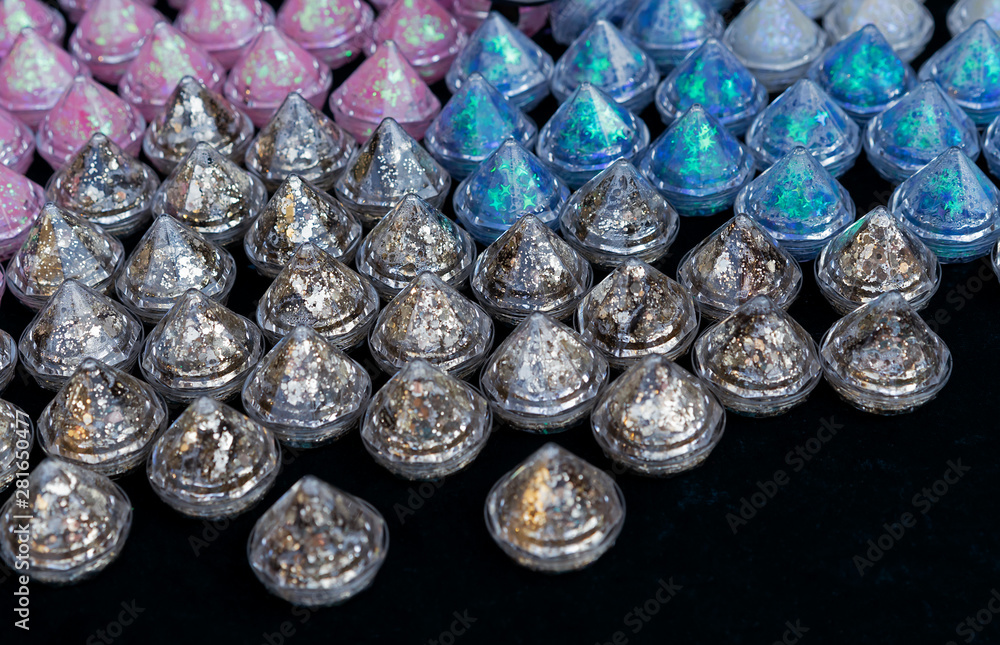Cosmetic sparkles in small transparent packages. Glitter for applying holiday makeup. Cosmetic sparkles in small transparent packages. Glitter for applying holiday makeup.
